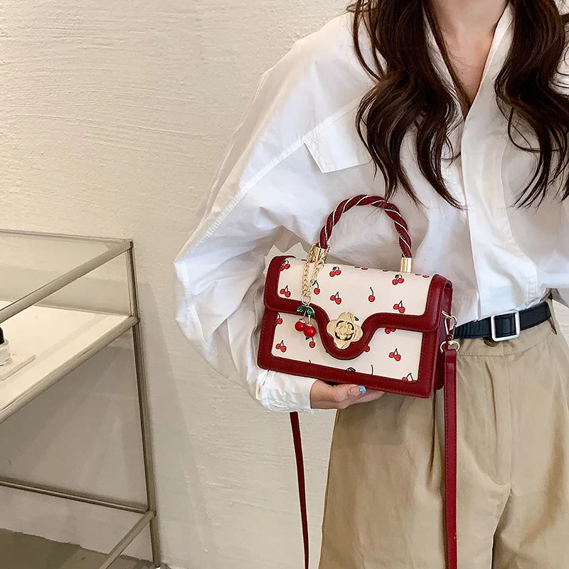 This Is a Red Handbag with a Cute Cherry Design for Dating and Shopping.